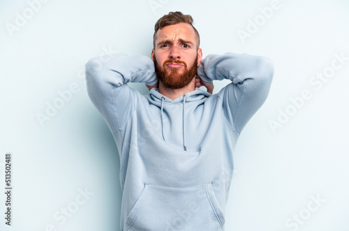Young caucasian man isolated on blue background screaming with rage. © Asier