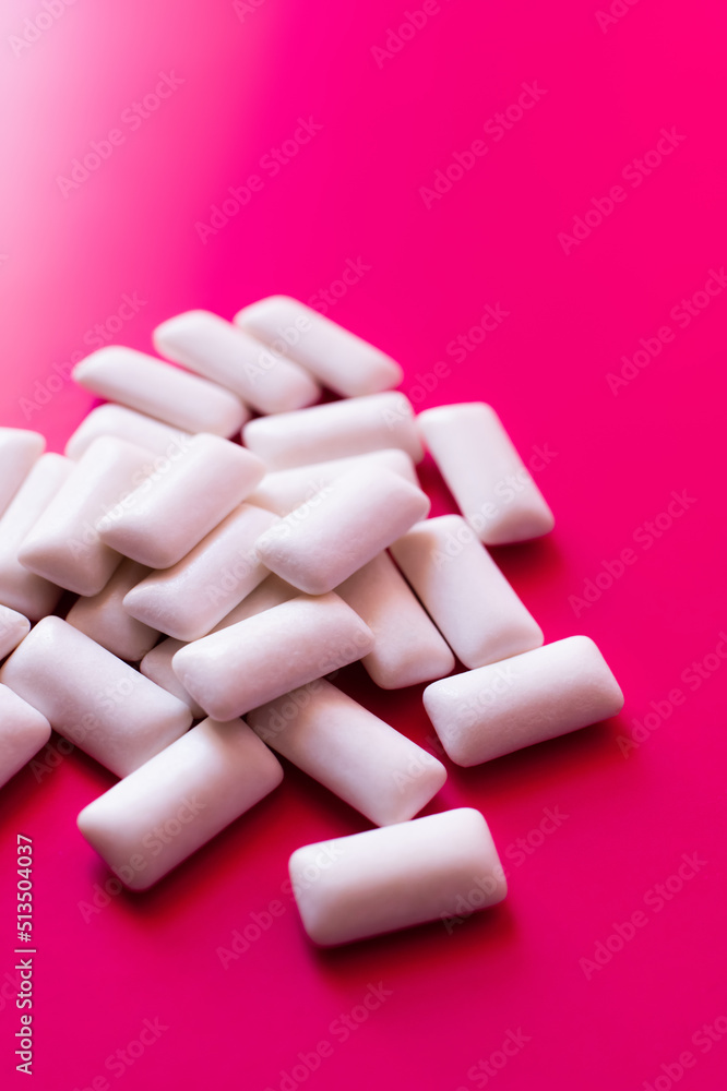 Close up view of white chewing gums on pink background. Close up view of white chewing gums on pink background.