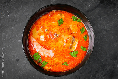 delicious hot traditional tom yam soup on a black background