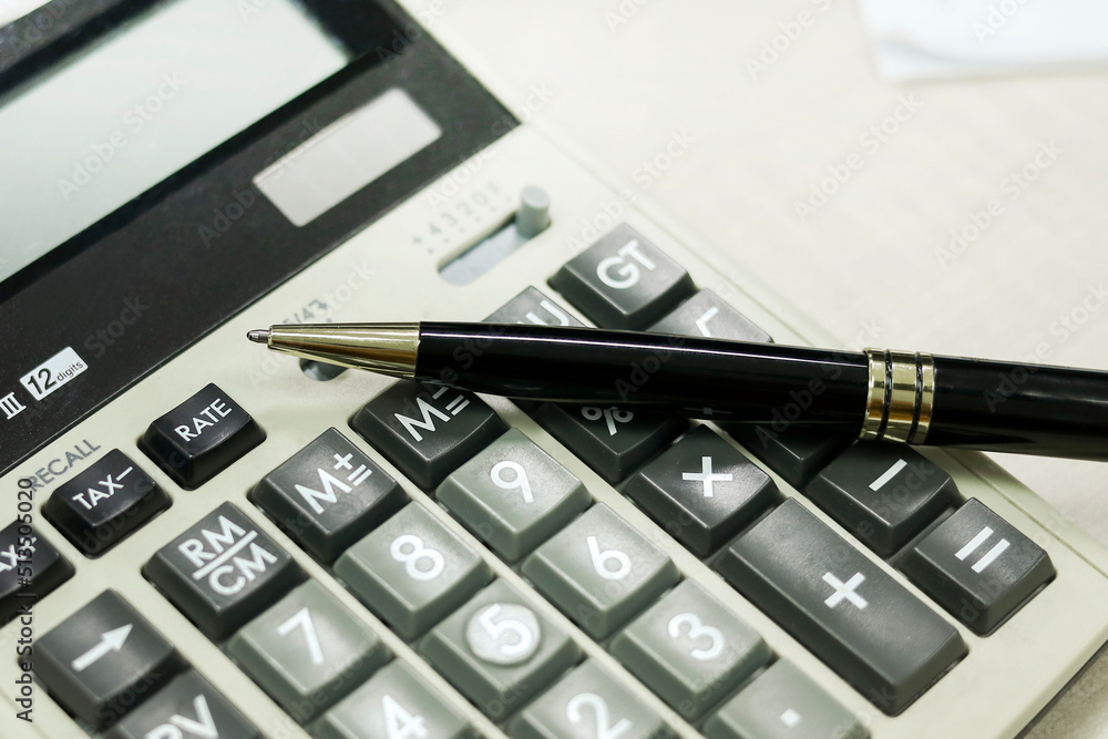 A ballpoint pointing to the word RATE on the calculator A ballpoint pointing to the word RATE on the calculator