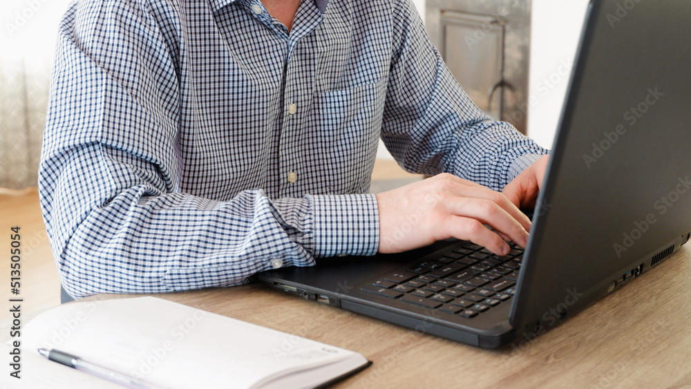 businessman working from home. Freelancer works on a laptop in the home office businessman working from home. Freelancer works on a laptop in the home office