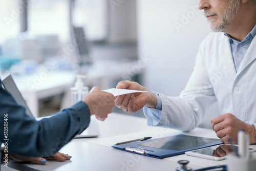 Doctor giving a certificate to his patient