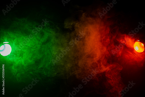 Red green smoke on a black background. 