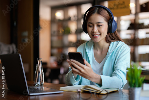 photo of woman wearing headphones and using mobile phone for online learning - educational course or training, seminar, education online concept