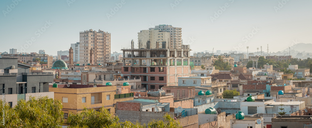 Wide panoramic view of African city of Oran in Algeria, shot of residental buildings and dirty facades on a sunny day with clear skies.