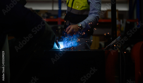 Welder working welding metal with Engineer to closely control the work in order to obtain the quality according to the prescribed form.