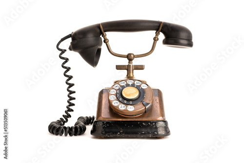 Old copper telephone with bakelite handset isolated on white background. 30s telephone photo