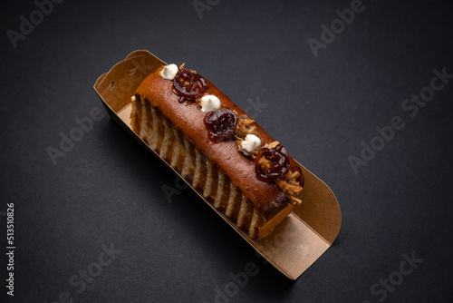 Hot dogs in paper plates with meat filling and sauce. On a black background
 photo