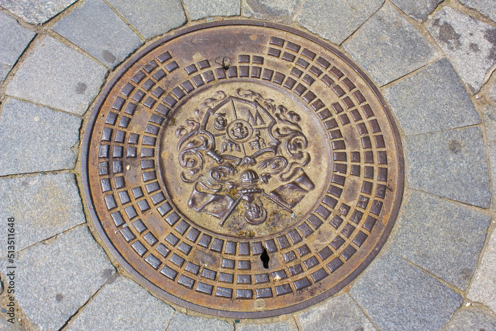Beautiful manhole bronze cover in Wroclaw	
