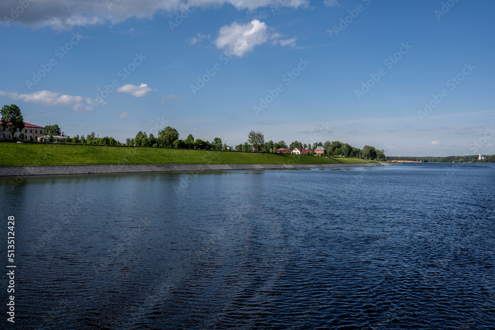an old white-stone monastery on the banks of the river on a summer day an old white-stone monastery on the banks of the river on a summer day