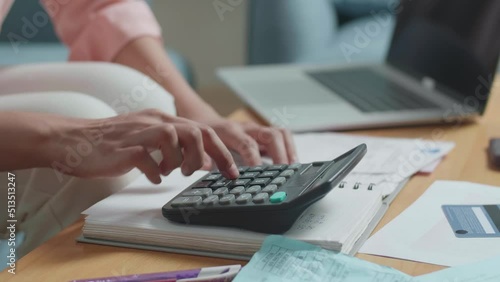 Close Up Of Woman'S Hand With The Bill Calculating Money By Calculator
 photo