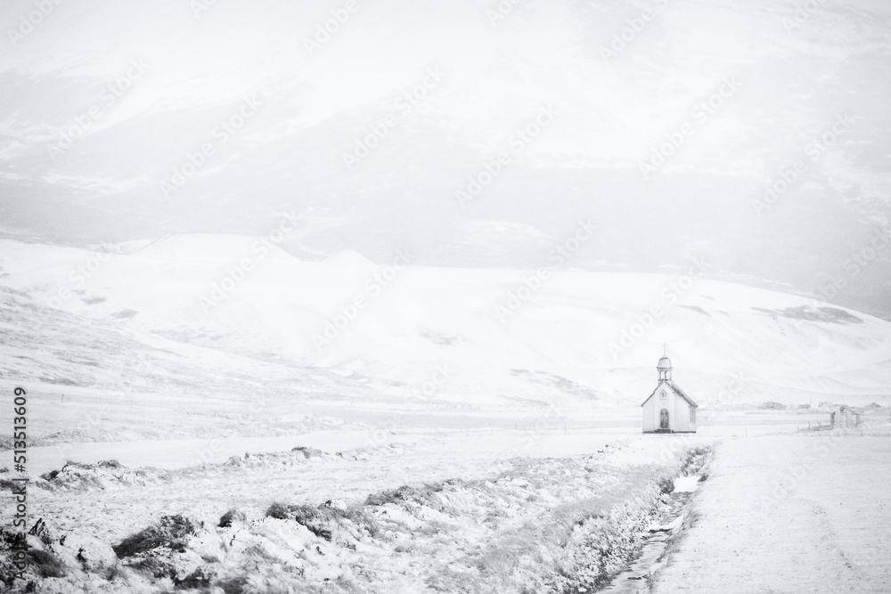 Landscape with snow covered chapel.