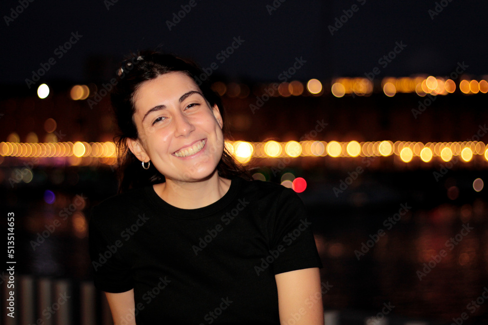Fototapeta premium portraying in a young woman in spontaneous moments, when she smiles