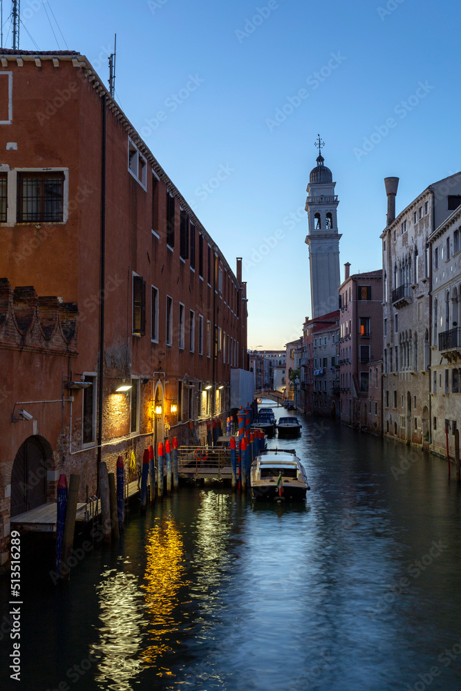 A narrow canal in Venice with the Church of Saint George of the Greeks in the background