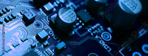 closeup on electronic circuit board with components and semiconductors, long banner