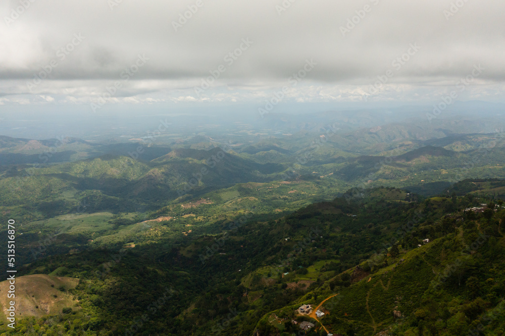 Aerial view of Tropical green forest in the mountains and jungle hills in the highlands of Sri Lanka.