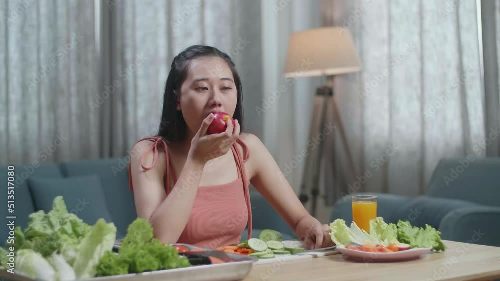 Happy Asian Woman Biting An Apple While Having Healthy Food At Home
Happy Asian Woman Biting An Apple While Having Healthy Food At Home