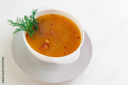 Pea soup with bacon and dill in a bowl on a white isolated. Selective focus. great design for the menu of your restaurant, cafe or design. Horizontal photo.