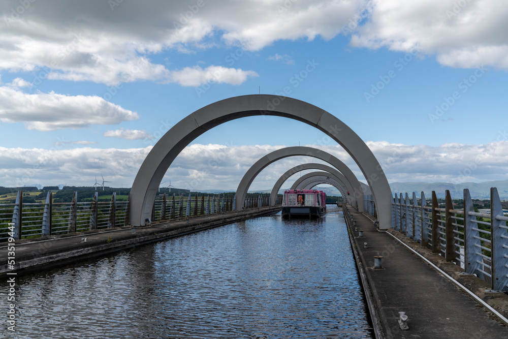 view of a tourist boat cruise on the Union Canal after leaving. The Falkirk Wheel hydraulic boat lift