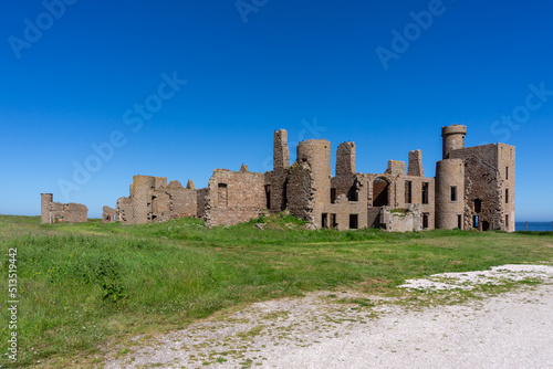 view of the historic Slains Castle ruins under a cloudless blue sky