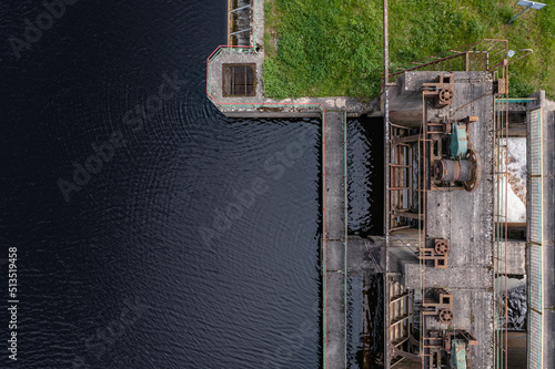 Aerial view of a small old dam on the river in summer © smiltena