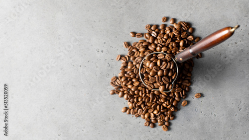 Turk with roasted coffee beans and grains around on a gray background. Copy space. photo