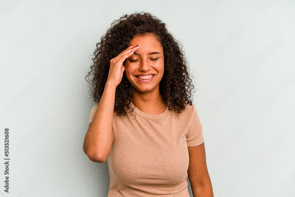 Young Brazilian woman isolated on blue background joyful laughing a lot. Happiness concept.