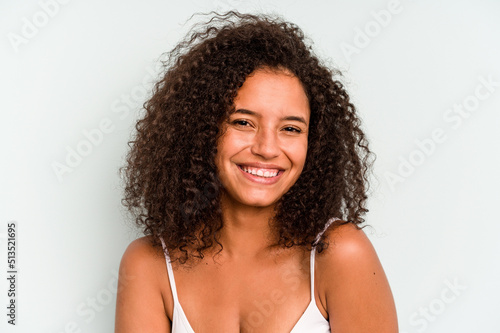 Young Brazilian woman isolated on blue background