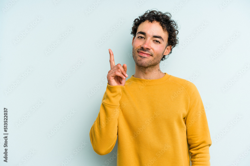 Young caucasian man isolated on blue background showing number one with finger. Young caucasian man isolated on blue background showing number one with finger.