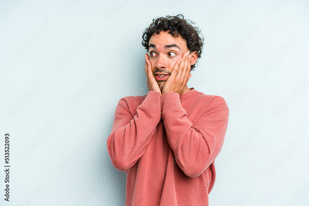 Young caucasian man isolated on blue background scared and afraid. Young caucasian man isolated on blue background scared and afraid.