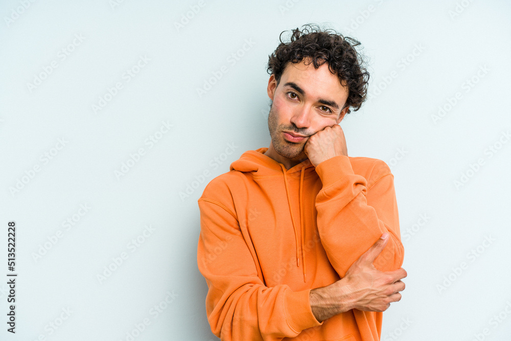 Young caucasian man isolated on blue background who feels sad and pensive, looking at copy space. Young caucasian man isolated on blue background who feels sad and pensive, looking at copy space.