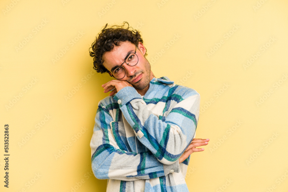 Fototapeta premium Young caucasian man isolated on yellow background tired of a repetitive task.