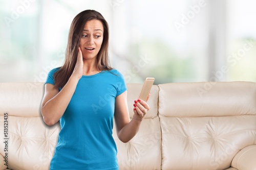 Focused millennial woman using mobile phone at home, online content, browsing internet, shopping with application. Free Download Focused millennial woman using mobile phone at home, online content, browsing internet, shopping with application. - GFXLoad