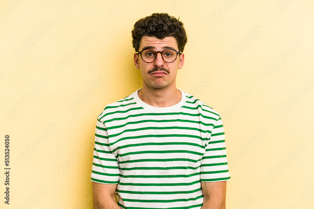 Young caucasian man isolated on yellow background sad, serious face, feeling miserable and displeased. Young caucasian man isolated on yellow background sad, serious face, feeling miserable and displeased.