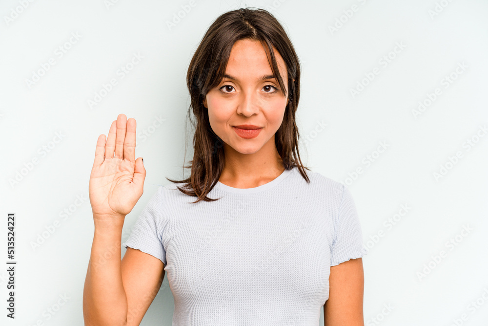 Young hispanic woman isolated on blue background holding a copy space on a palm. Young hispanic woman isolated on blue background holding a copy space on a palm.
