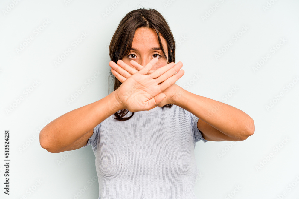 Young hispanic woman isolated on blue background relaxed thinking about something looking at a copy space. Young hispanic woman isolated on blue background relaxed thinking about something looking at a copy space.