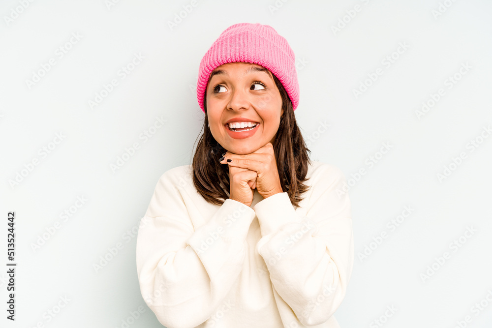 Young hispanic woman isolated on blue background trying to listening a gossip. Young hispanic woman isolated on blue background trying to listening a gossip.