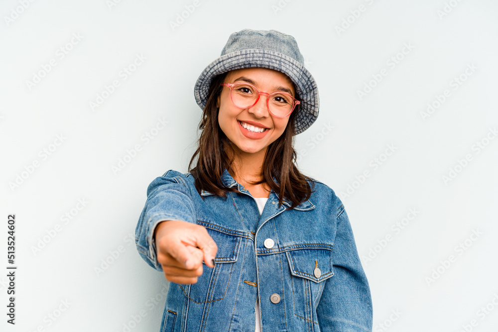 Young hispanic woman isolated on blue background showing a dislike gesture, thumbs down. Disagreement concept. Young hispanic woman isolated on blue background showing a dislike gesture, thumbs down. Disagreement concept.