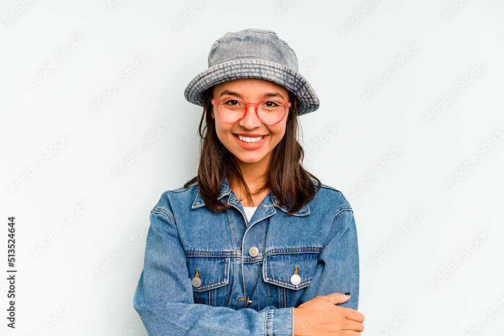 Young hispanic woman isolated on blue background shouts loud, keeps eyes opened and hands tense. Young hispanic woman isolated on blue background shouts loud, keeps eyes opened and hands tense.