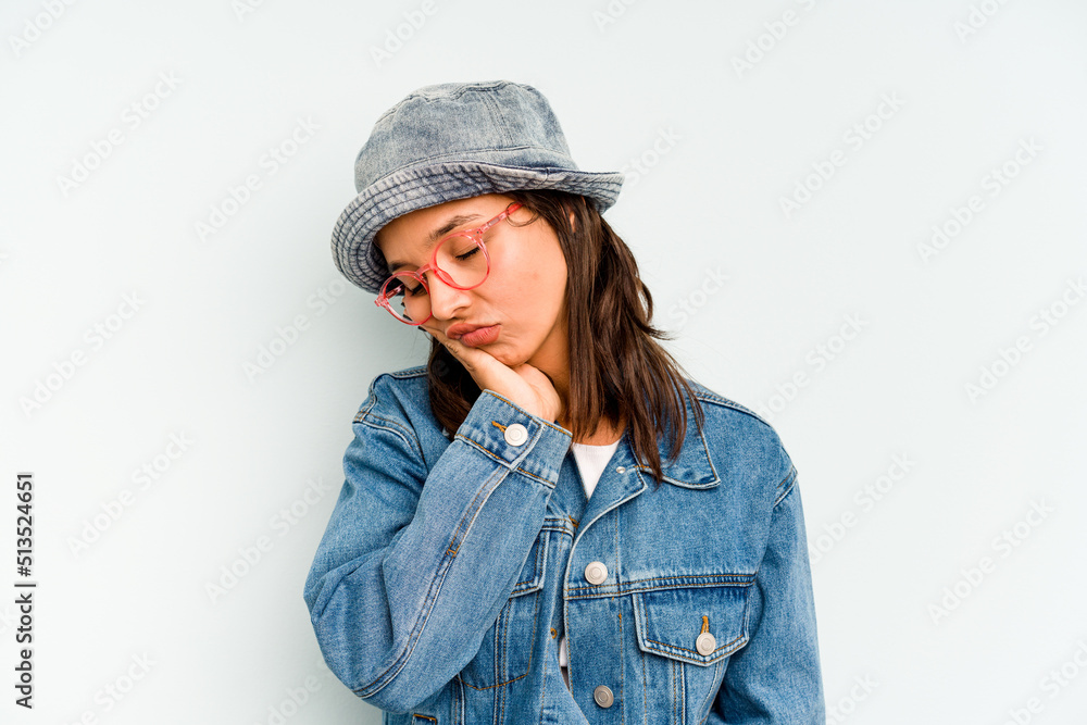 Young hispanic woman isolated on blue background relaxed thinking about something looking at a copy space. Young hispanic woman isolated on blue background relaxed thinking about something looking at a copy space.