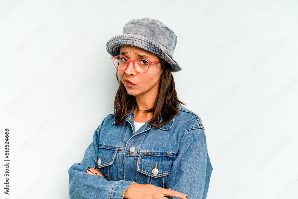 Young hispanic woman isolated on blue background smiles, pointing fingers at mouth. Young hispanic woman isolated on blue background smiles, pointing fingers at mouth.