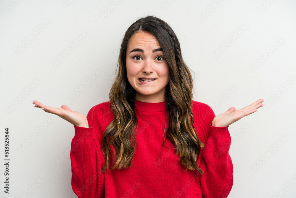 Young caucasian woman isolated on white background confused and doubtful shrugging shoulders to hold a copy space. Young caucasian woman isolated on white background confused and doubtful shrugging shoulders to hold a copy space.