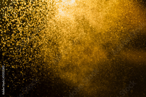 Dark golden bokeh glitter texture background