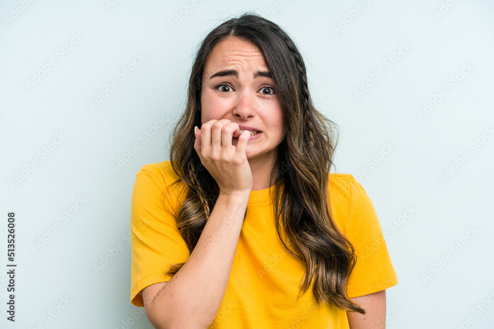 Young caucasian woman isolated on blue background biting fingernails, nervous and very anxious. Young caucasian woman isolated on blue background biting fingernails, nervous and very anxious.