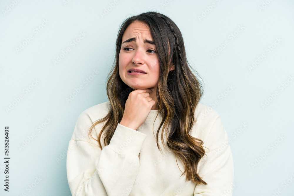 Young caucasian woman isolated on blue background suffers pain in throat due a virus or infection. Young caucasian woman isolated on blue background suffers pain in throat due a virus or infection.