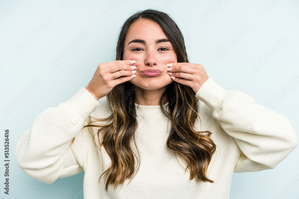 Young caucasian woman isolated on blue background doubting between two options. Young caucasian woman isolated on blue background doubting between two options.