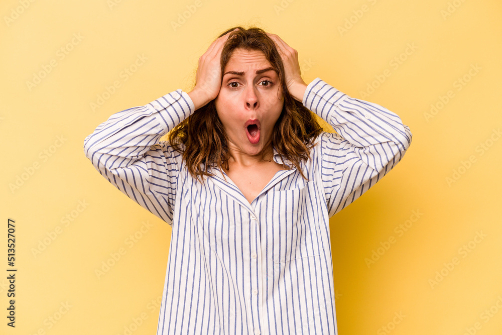 Young caucasian woman isolated on yellow background being shocked, she has remembered important meeting. Young caucasian woman isolated on yellow background being shocked, she has remembered important meeting.