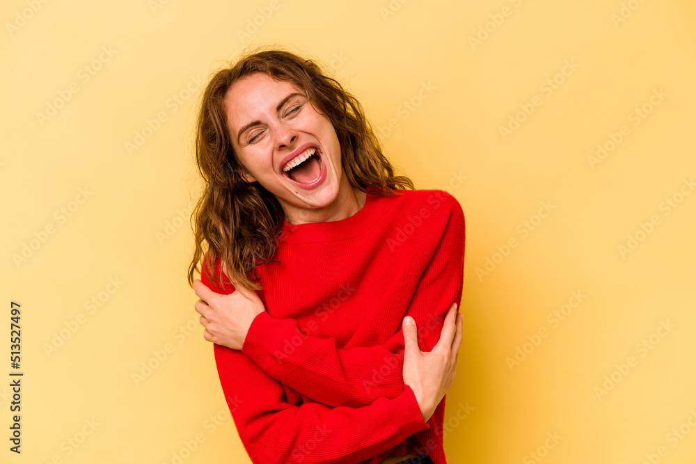 Young caucasian woman isolated on yellow background laughing and having fun. Young caucasian woman isolated on yellow background laughing and having fun.