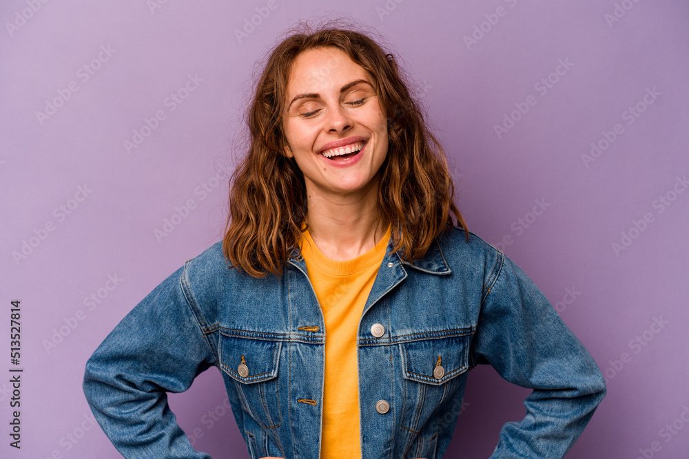 Young caucasian woman isolated on purple background confident keeping hands on hips. Young caucasian woman isolated on purple background confident keeping hands on hips.