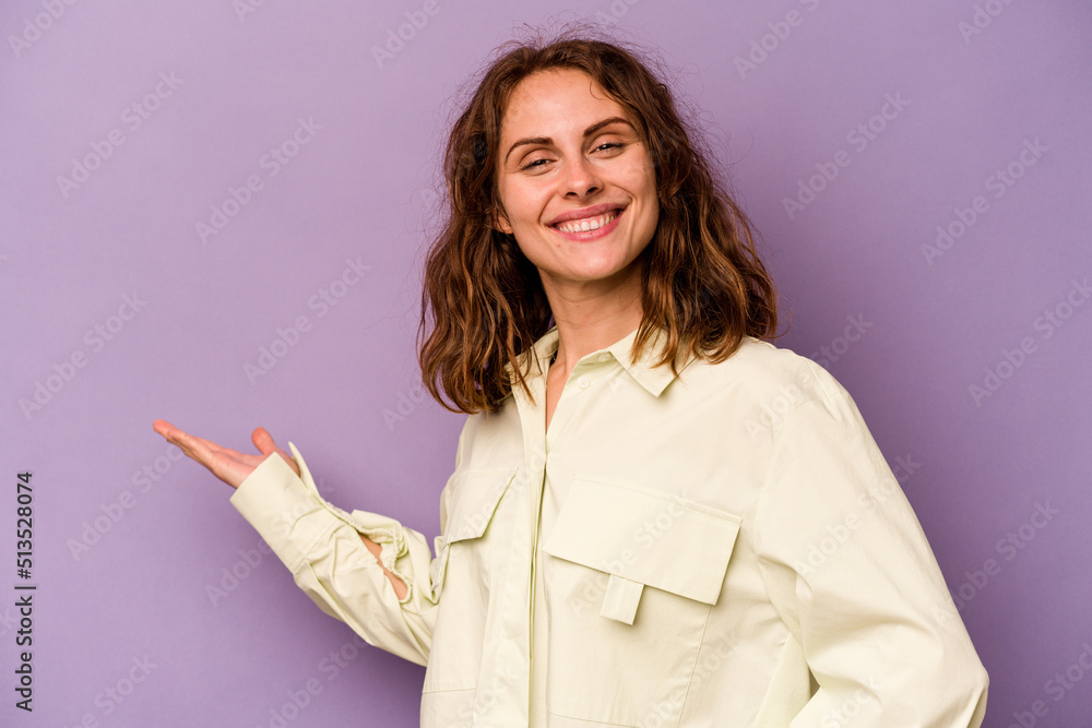 Young caucasian woman isolated on purple background showing a welcome expression. Young caucasian woman isolated on purple background showing a welcome expression.